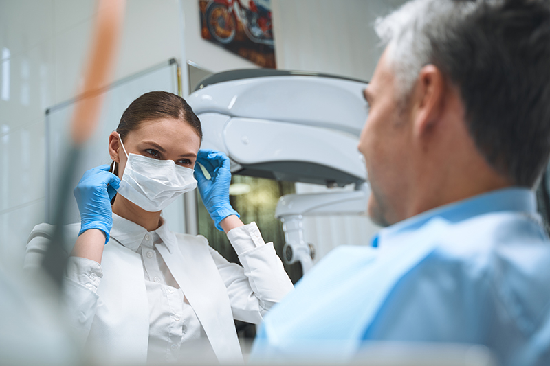 cheerful dentist seeing patient in office stock ph P59RRJ2