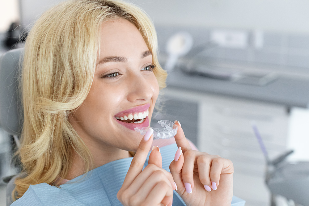 young attractive woman holding invisible braces or WTY6WLP